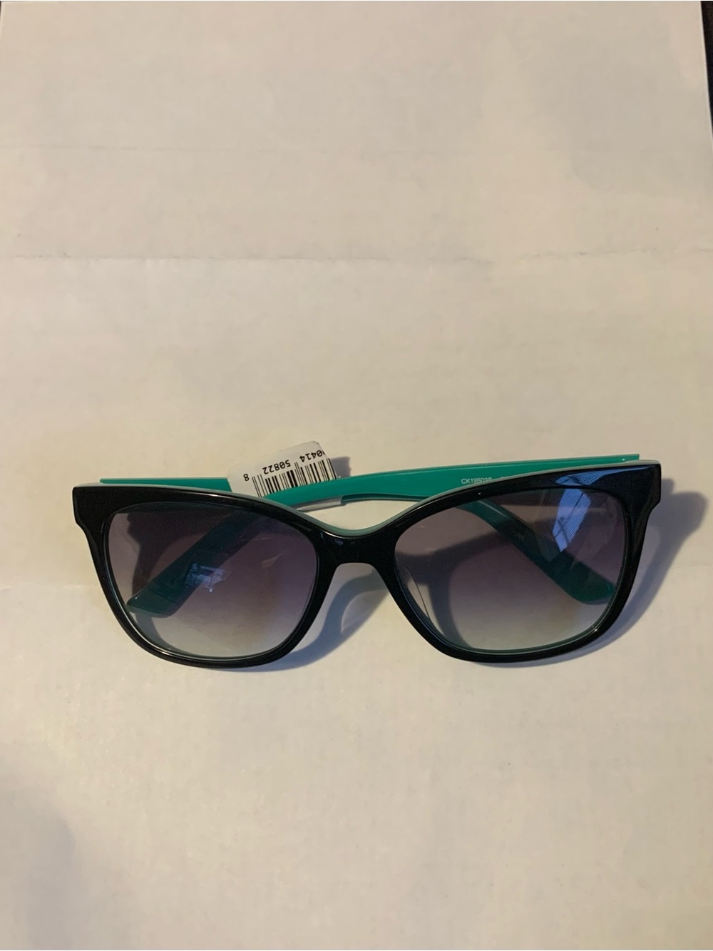 Calvin Klein Women’s Black Front Sunglasses with Teal Temples